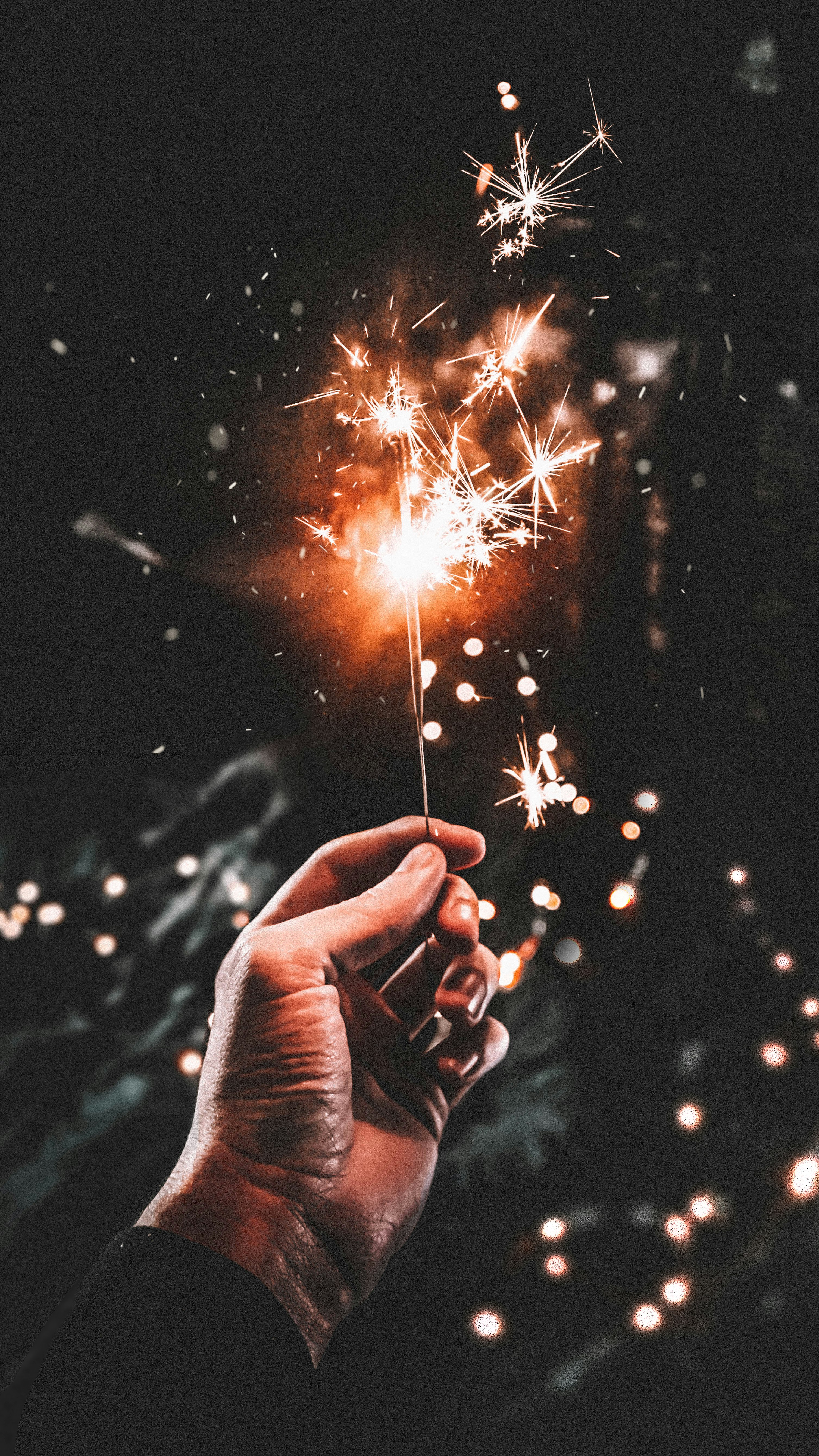 time-lapse photography of person holding firecracker